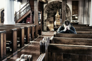 Praying in an Anglican church, UK